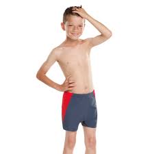 Boy wears grey swim shorts with red panels